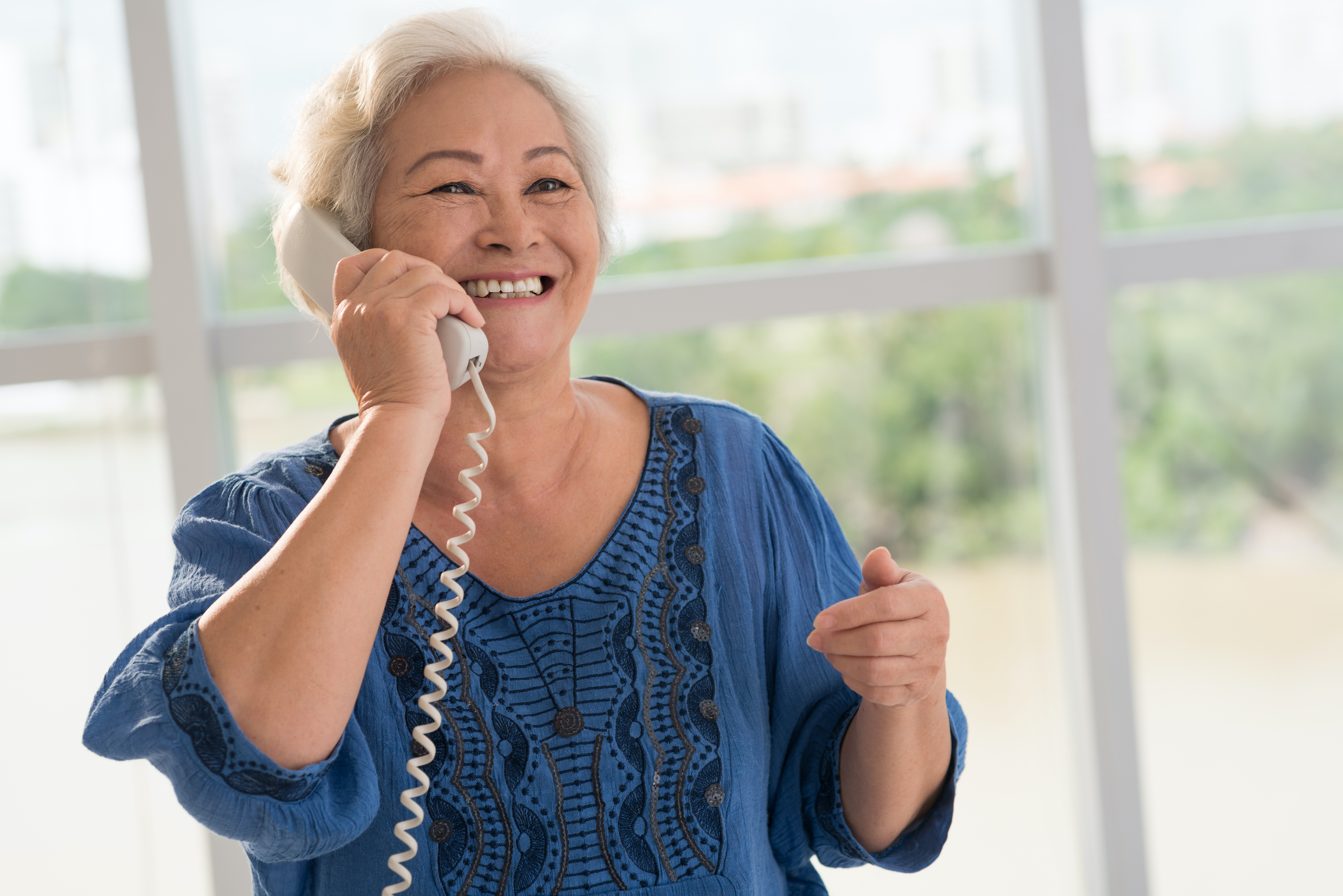 elderly woman talking on the phone